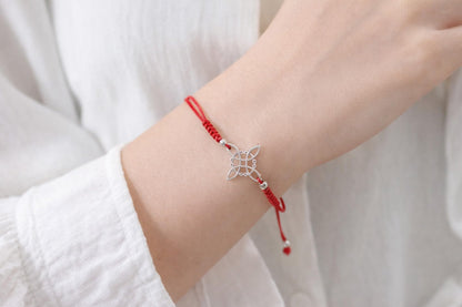 AeraVida Adjustable Red Witches Knot Bracelet with Sterling Silver Flower Charm – 19mm Symbol Centerpiece, Cotton Rope Band 6 to 9 Inches, Sliding Knot Closure