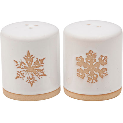 Primitives by Kathy Winter Salt & Pepper Set - stoneware salt and pepper shakers displaying a snowy cream color with individual debossed snowflake designs and bare ceramic accents