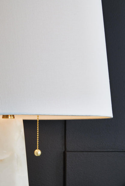 Signature Design by Ashley Laurellen Contemporary Table Lamp with 2 Sockets and Pull Chain Switch, Fabric Shade, Resin and Alabaster, 23.25" High, White